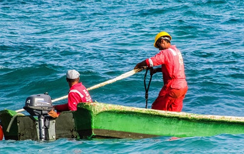 workers on a boat in the open sea